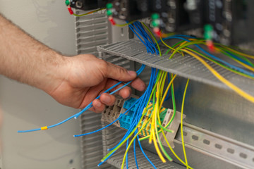 electrician connecting wire on the control panel