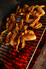 Crispy chicken wings cooking on a grill