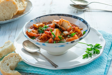 Tiger prawn and fish stew in a bowl