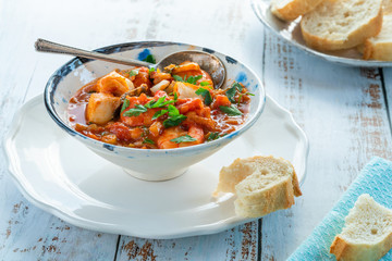 Tiger prawn and fish stew in a bowl