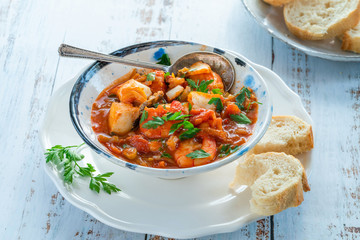 Tiger prawn and fish stew in a bowl