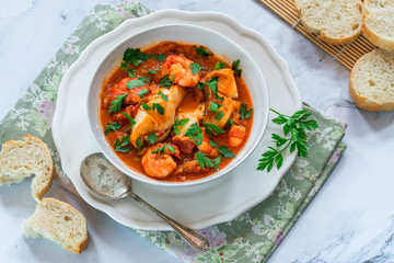 Tiger prawn and fish stew in a bowl- top view
