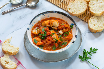 Tiger prawn and fish stew in a bowl