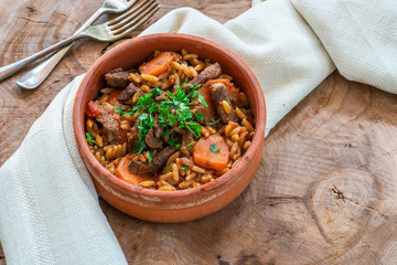 Giouvetsi - traditional Greek baked dish with beef and orzo pasta in tomato sauce.