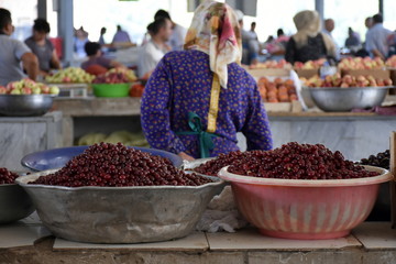 Woman selling cherries on Chorsu Bazaar in Tashkent, Uzbekistan