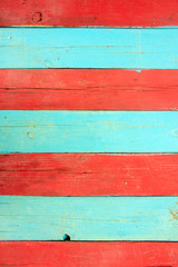 Red and blue wooden wall. The natural surface of painted wood.