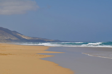 Beautiful empty sandy beach Cofete, Fuerteventura Canarias. Mountains background 