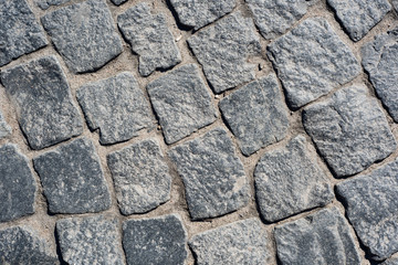 Broken paving blocks of rectangular stones