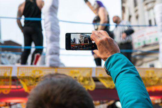 Man who makes videos and photos with a mobile phone on the great carnival parade.