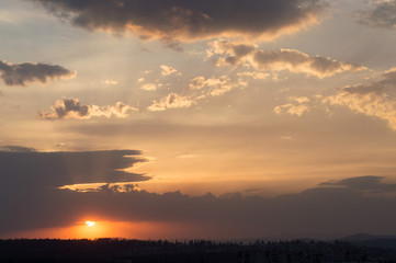 Late summer sunset in cloudy weather. Romantic and warm twilight.