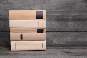 Stack of old books on wooden background