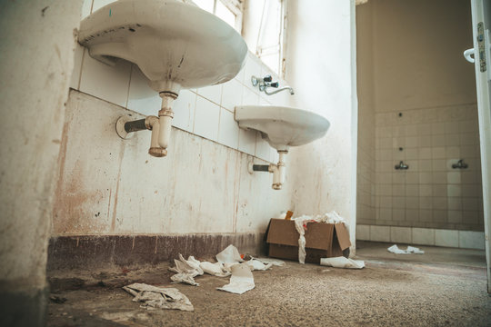 old dirty toilet in abandoned psychiatric hospital building. dirt and disorder on social facilities