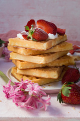 A stack of waffles with strawberries