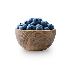 Blueberries in a wooden bowl. Ripe blueberries with copy space for text. Blueberry isolated on white. Bilberries on a white background.