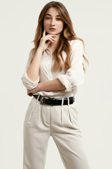 Gorgeous female brunette model in white clothes