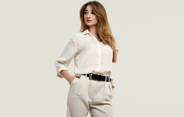 Gorgeous female brunette model in white clothes