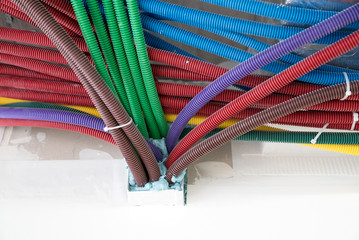 colorful plastic tubes for electrical wires in the sub ceiling in a massive wiring system
