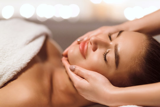 Facial Beauty Treatment. Woman Getting Face Massage