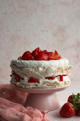 A Cake Made From Layers of Meringue, Whipped Cream, and Fresh strawberries.
