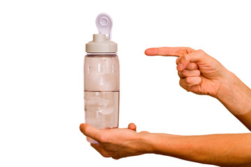 A young guy holds a bottle of water in his hand. The concept of proper nutrition and diet