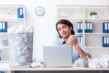 Businessman rejecting new ideas with lots of papers