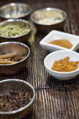 Closeup of a variety of spices in metal bowls for making Masa tea in a yoga studio