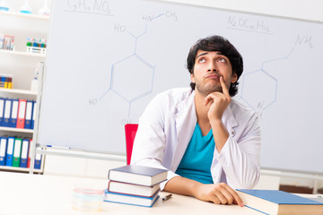 Young student chemist in the classroom 