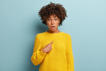 Image of amazed indignant surprised young lady has curly Afro hairstyle, being speechless, points...