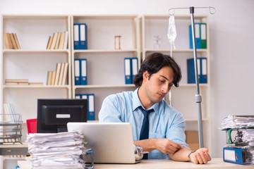 Young male employee in blood transfusion concept