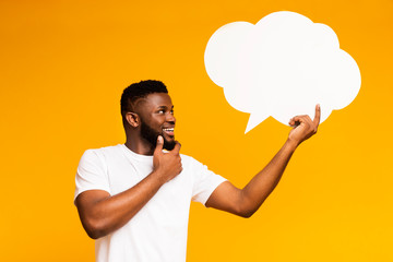 African-american man looking at blank speech bubble