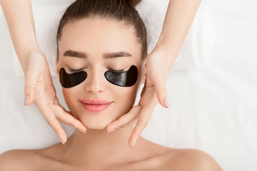 Face Massage. Woman With Black Eye Patches