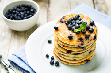Blueberry Ricotta Pancakes with fresh blueberries and cup of coffee