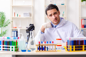 Young male chemist working in the lab 