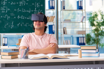 Young male student in the classroom 
