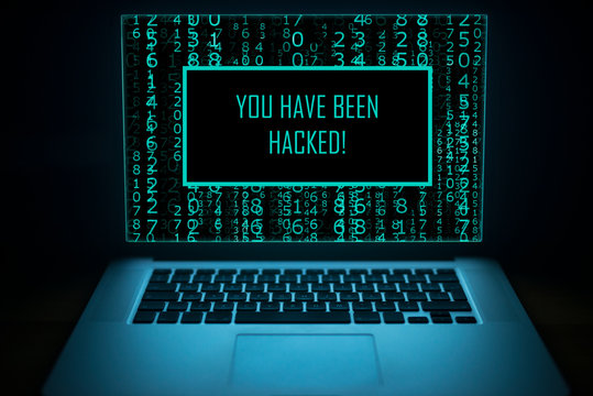 Hacked. Internet crime concept.  Computer display with message YOU HAVE BEEN HACKED. Network security data protection.