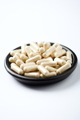 Sulforaphane capsules.  Concept for a healthy dietary supplementation. White background. Close up. Copy space.