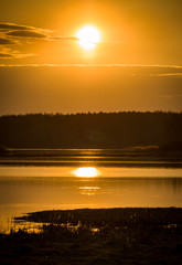 Fototapeta na wymiar Early spring. Beautiful sunset on the wild nature. Forest river