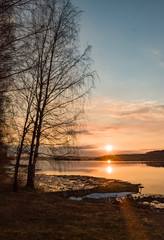 Fototapeta na wymiar Early spring. Beautiful sunset on the wild nature. Forest river