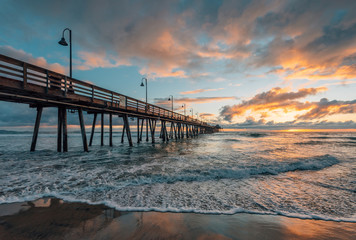 Fototapeta na wymiar The pier and Pacific Ocean at sunset, in Imperial Beach, near San Diego, California