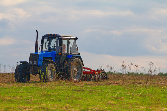 Tractor with plow in the field