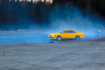 YCar drifting. Yellow sports car in the drifting competition.