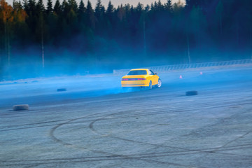 YCar drifting. Yellow sports car in the drifting competition.