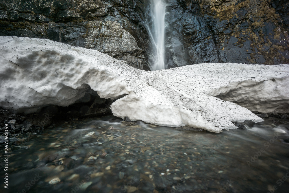 Poster ice block in front of gveleti waterfall