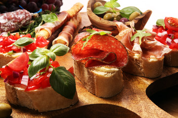 Traditional italian antipasto bruschetta appetizer with cherry tomatoes, cream cheese, basil leaves...