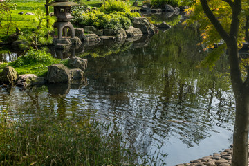 Japanese garden decorated with Japanese stone lanterns, flowers and stone floors.