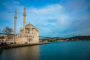 Fototapeta na wymiar View of the Ortakoy Mosque in Istanbul City of Turkey. Historical Tower and sunset at Bosphorus. 