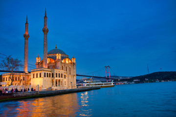 Fototapeta na wymiar View of the Ortakoy Mosque in Istanbul City of Turkey. Historical Tower and sunset at Bosphorus. 