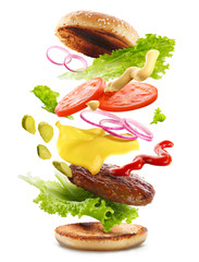 Delicious burger with floating ingredients, isolated on white background - obrazy, fototapety, plakaty