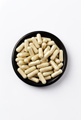 Sulforaphane capsules.  Concept for a healthy dietary supplementation. White background. Top view....
