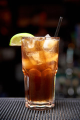 Cold cocktail on a dark blurred background with bokeh.